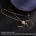 Rotating golden daisy necklace in titanium steel with zircon petals on black background - Rotating Flower (A190)