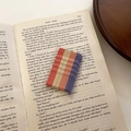 Detail shot of vintage Morandi color wavy hairpins set on English book background - Wave