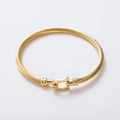 Golden stainless steel twisted wire bracelet with U-shaped horseshoe magnetic clasp - Gold