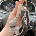 Portachiavi con orsetto di cristallo e cinturino di lusso in strass con finitura cangiante - Bianco AB