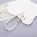 Elegant pearl phone charm with gold flower pendant and faceted beads on white stand - K043 White Pearl