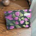 Retro cosmetic bag with purple flower brocade on black wood tabletop - Shell Flower Rose Red
