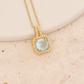 Close-up of golden square pendant with light blue gemstone and shimmering crystal border - Square Light Blue Gem Style (10#)