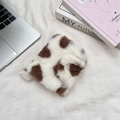 Flat lay of soft plush storage pouch featuring a trendy cow print texture and fluffy finish - White Heart