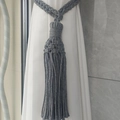 Detail view of handmade grey cotton woven curtain tieback with long decorative tassels - Gray