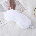 Soft white faux rabbit fur sleep mask with elastic strap on plush texture background - White
