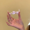 Close-up of a hand holding a delicate pearl and pink crystal bow hair clip with fine details - Pink