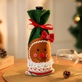 Detailed view of gingerbread man Christmas wine bottle cover with lace and bow - Green