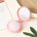 Pink foldable travel hairbrush with massage cushion and round mirror for quick styling - Pink