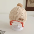 Detail of baby knit hat showing soft beige cable stitch and orange faux fur lining - 1-2 years old / Light Khaki