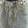Golden rhinestone waist chain with diamond-shaped accents and heart pendant on denim - Gold Rhombus
