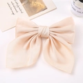 Champagne large satin bow hair clip on a clean white desk with elegant aesthetic decor - Off-white