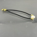 Detailed view of black Milan cord bracelet with a large white pearl and gold clasp - Black