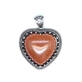 Macro shot of heart-shaped natural stone pendant with vintage beaded silver frame - Gold Sandstone