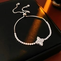 Close-up of adjustable silver zircon flower bracelet with clover charm on black leather - Silver