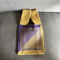 Detail of knit tote bag featuring purple and yellow geometric square spiral patterns - Kaleidoscope Yellow