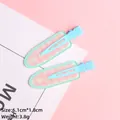 Detail of mint green and pink checkerboard duckbill hair clips on a soft pastel background - Blue With Pink Grid