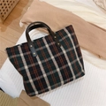 Detail view of vintage British style plaid tote bag with sturdy leather handles and rivets - Green and White Plaid