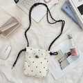 Detailed view of floral canvas crossbody bag with drawstring and braided strap - Small Flower White