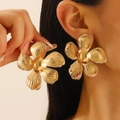 Statement gold floral earrings with textured petals and metallic finish on female model - Large Gold Five-Petal Flower (0587)