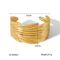 Detailed view of 18K gold plated feather cuff bangle with layered leaf textures - Hc-b20022