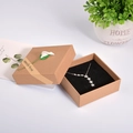 Kraft paper jewelry box with white flower and star necklace in black sponge liner - 8.5x8.5x3.5cm