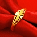 Golden clover ring with gold finish resting on elegant red silk fabric background - Four-Leaf Clover Shape (J111517)