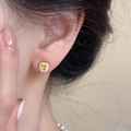 Sterling silver earring with yellow square diamond and halo on ear of a model - Gold With Yellow Rhinestone