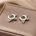 Macro shot of silver geometric hoop earrings with metal bead accents on silk background - Silver Round Ball