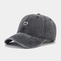 Close-up of fine heart embroidery on vintage washed charcoal grey baseball cap - Black