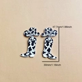 Acrylic cowboy boot and hat earrings with black and white cow print and size measurements - Cow Print Boots and Hat