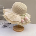 Beige straw sun hat with white lace trim and pink tulip floral accent on a wooden stand - Beige Tulip