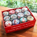 12-pack Christmas tin gift boxes in a red display tray with festive holiday designs - Set of 24 Pieces