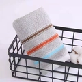 Folded grey cotton towel with orange and blue stripes in a black metal basket - Weak Twist Dotted Satin Grey / 34*74cm