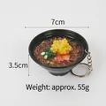 Miniature ramen bowl keychain with noodles and egg details on white background - Garlic Soba Noodles Keychain