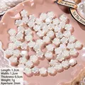 Detailed view of white rose shaped pearl beads with holes for DIY jewelry making - Rose