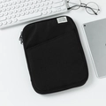 Detail of black padded iPad sleeve with front pocket and zipper on minimalist desk - 13" / Black