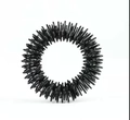 Close-up of black metal spiral spring finger massage ring for stress relief - Black