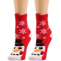 Detail of red knitted Christmas socks featuring a snowman and snowflake pattern on a mannequin - One Size / Red/Penguin