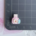 Macro shot of mini pink bear resin camera accessory showing 1.5cm size on a scale ruler - Pink Instax Camera