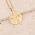 Macro shot of 18K gold zodiac pendant with trident relief on textured coin necklace - 11#Sagittarius