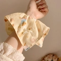 Floral scrunchie with bear and croissant patterns on light yellow fabric and white bow - Cartoon Bear