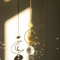 Golden sun and moon suncatcher with faceted crystal ball projecting rainbow light - Design No.4 / 30cm