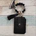 Detail of black faux leather card wallet with silicone beaded wristlet and tassel - Black