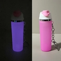 Luminous pink silicone mini water bottle keychain with metal clasp showing glow-in-dark effect - Night Light Pink