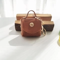 Brown faux leather mini coin purse keychain with gold metal clasp and wave texture - Coffee