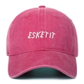 Detailed close-up of ESKETIT embroidery on a washed rose pink vintage baseball cap - Rose Red