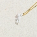 Minimalist golden necklace featuring a cute white bear pendant on stone surface - Small Bear / White