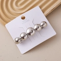 Detail of silver metallic hair clip with five spherical beads on branded display card - Polished Ball Chain Silver