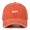 Detailed close-up of white 3D embroidery and washed cotton texture on vintage orange cap - Orange